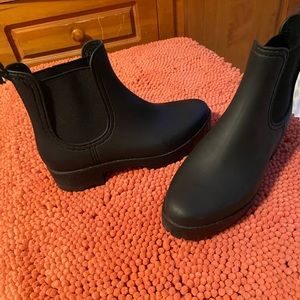 Rubber rain boots with lug sole.